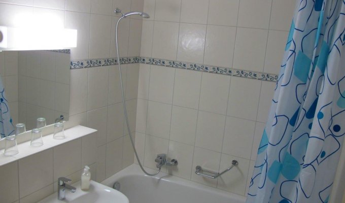A bathroom with bathtub, sink and toilet