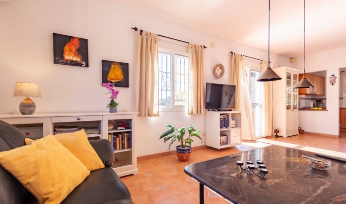 Living room with TV and open kitchen