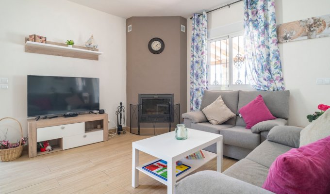 Living room with TV set and fireplace