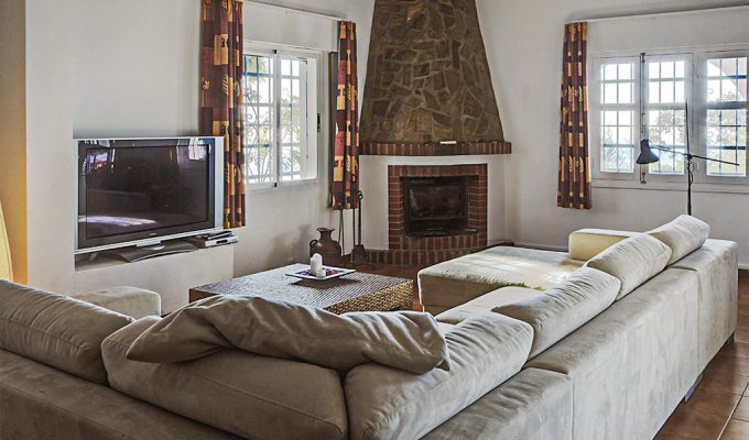 Living room with TV and fireplace