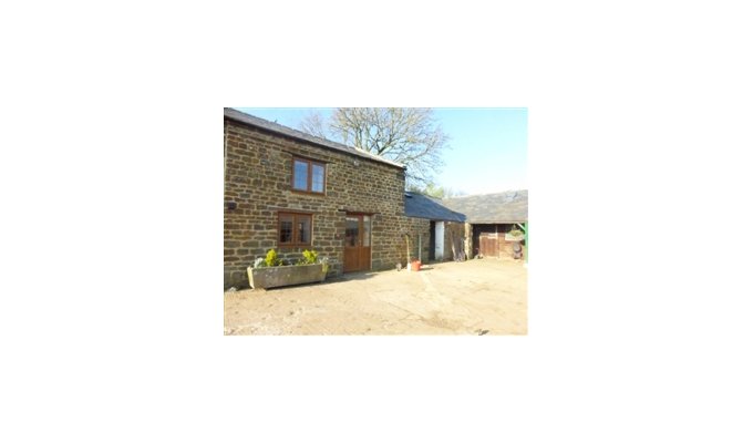 Stable cottage looking out at horses