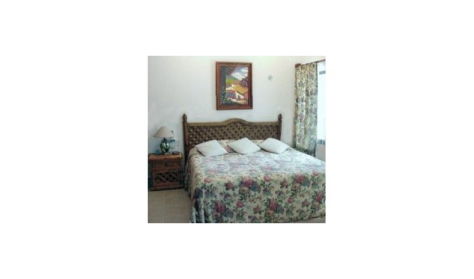 This upstairs bedroom is off a small private screened porch