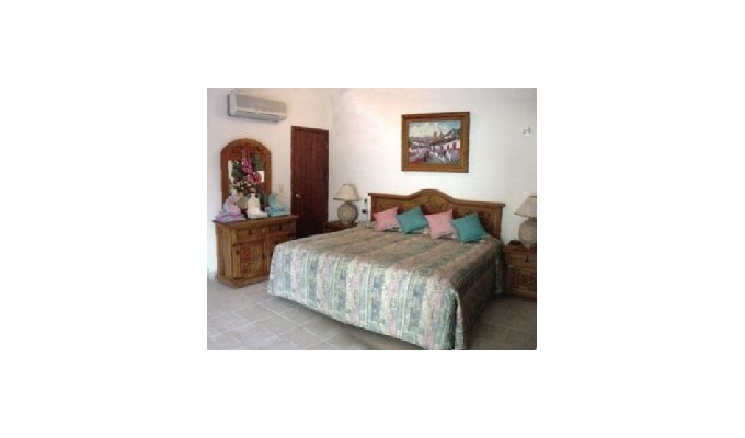 The king size bed in the front bedroom  